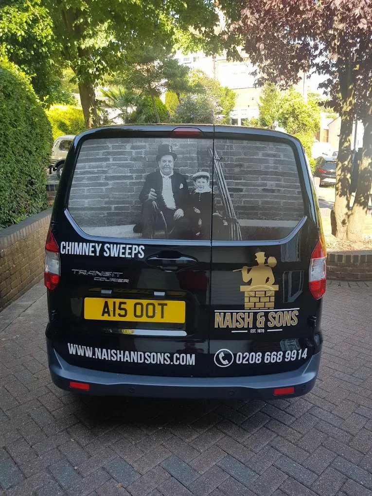 The black and gold Naish & Sons chimney sweep van, carrying the family photograph on the rear window